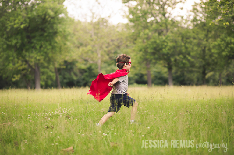 boy in superhero cape running in field la grange illinois