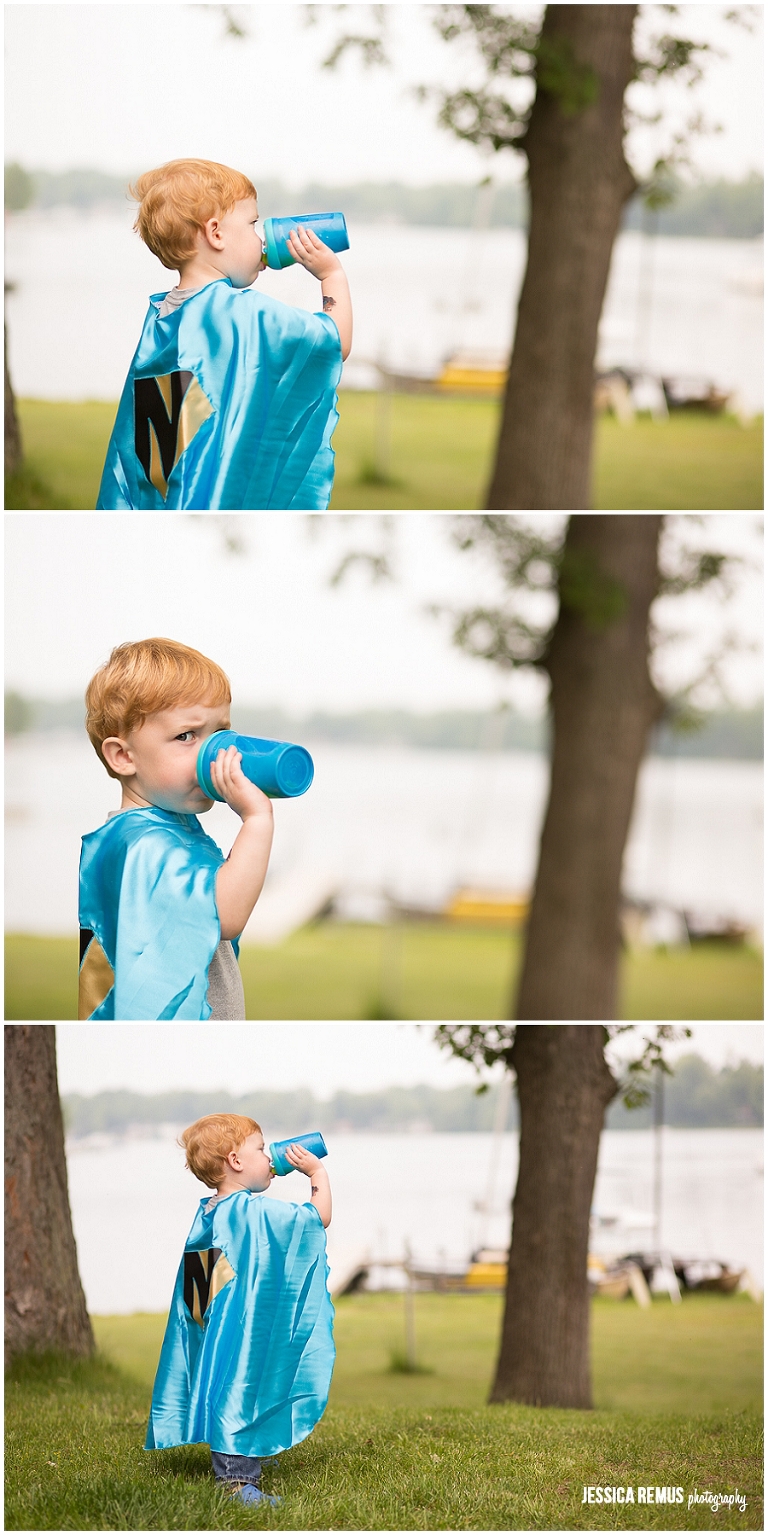 toddler boy with superhero cape and sippy cup chicago park